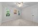 Comfortable bedroom featuring neutral carpet, two large windows, and a ceiling fan at 2840 Mattlyn Ct, Raleigh, NC 27613