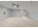 Spacious bonus room featuring neutral carpet, vaulted ceiling, and bright windows at 2840 Mattlyn Ct, Raleigh, NC 27613