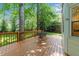 Cozy outdoor deck with table and chairs, surrounded by lush greenery and partial view of the home at 2840 Mattlyn Ct, Raleigh, NC 27613