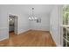 Inviting dining room featuring hardwood floors, bright windows, and modern chandelier at 2840 Mattlyn Ct, Raleigh, NC 27613