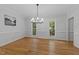Elegant dining room featuring hardwood floors, bright windows, and a modern chandelier at 2840 Mattlyn Ct, Raleigh, NC 27613