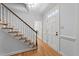 Welcoming foyer featuring hardwood floors, carpeted stairs, and a front door at 2840 Mattlyn Ct, Raleigh, NC 27613