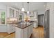 Well-appointed kitchen with white cabinetry, granite countertops, and stainless steel appliances at 2840 Mattlyn Ct, Raleigh, NC 27613