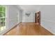 Light-filled room with beautiful hardwood floors, neutral walls, and classic molding at 2840 Mattlyn Ct, Raleigh, NC 27613