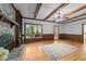Cozy living room with hardwood floors, brick fireplace, wood paneling, and built-in shelving at 2840 Mattlyn Ct, Raleigh, NC 27613