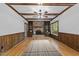 Inviting living room with a brick fireplace, hardwood floors, ceiling beams, and built-in shelving at 2840 Mattlyn Ct, Raleigh, NC 27613