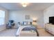 Bright bedroom with a comfortable bed and an ample workspace, creating a versatile area at 2929 Great Lawn Rd, Apex, NC 27502