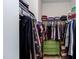 Walk-in closet with ample storage, organized shelving, and unique green chest of drawers at 2929 Great Lawn Rd, Apex, NC 27502