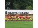 Community entrance sign surrounded by colorful flowers and lush greenery at 2929 Great Lawn Rd, Apex, NC 27502