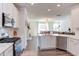 Open concept kitchen boasts stainless steel appliances and flows into the living room at 2929 Great Lawn Rd, Apex, NC 27502