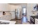 Modern kitchen with white cabinets, stainless steel appliances, and hardwood floors, creating a sleek and functional space at 2929 Great Lawn Rd, Apex, NC 27502