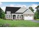 Charming home features a stone and siding exterior, a two-car garage, and a well-manicured lawn at 297 Crop Rd, Angier, NC 27501