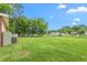 Large grassy backyard featuring mature trees and open space, perfect for outdoor activities and relaxation at 310 Wood St, Gibsonville, NC 27249