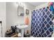 Bathroom featuring a pedestal sink, decorative mirror, and a shower with a patterned curtain at 310 Wood St, Gibsonville, NC 27249