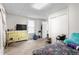 Bright bedroom with a window, carpet flooring, and an organized closet, offering a peaceful retreat at 310 Wood St, Gibsonville, NC 27249