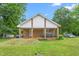 Charming ranch-style home with a covered porch and a well-maintained front lawn at 310 Wood St, Gibsonville, NC 27249