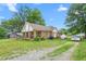 Spacious property featuring a ranch-style home with a covered front porch and driveway at 310 Wood St, Gibsonville, NC 27249