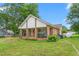 Inviting ranch-style home with a cozy covered front porch and a well-kept front lawn at 310 Wood St, Gibsonville, NC 27249