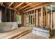 Unfinished interior with exposed framing and wooden beams showing room for customization and design at 310 Wood St, Gibsonville, NC 27249