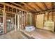 Unfinished interior with exposed framework and piles of wood, presenting a blank canvas for renovation at 310 Wood St, Gibsonville, NC 27249