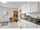 Bright kitchen with ample counter space and lots of natural light from the exterior door at 310 Wood St, Gibsonville, NC 27249