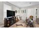Cozy living room featuring a large TV and decorative fireplace with natural light coming from the windows at 310 Wood St, Gibsonville, NC 27249