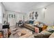 Comfortable living room with cozy couches, carpeted floors, and Gathering photos adorning the wall at 310 Wood St, Gibsonville, NC 27249