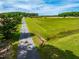 Expansive aerial view showcases the property's long driveway and vast green space at 3187 Wilsons Mills Rd, Smithfield, NC 27577