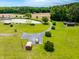 Expansive aerial view of property featuring a pond, outbuildings, and a long driveway at 3187 Wilsons Mills Rd, Smithfield, NC 27577