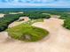 Expansive aerial view featuring cultivated fields and a pond, complemented by lush surrounding woodlands at 3187 Wilsons Mills Rd, Smithfield, NC 27577