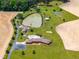 Aerial view of a home with a pool, pond, and spacious manicured lawns at 3187 Wilsons Mills Rd, Smithfield, NC 27577