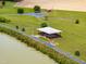 Scenic aerial view of outdoor pavilion, walking path, and serene pond showcasing community amenities at 3187 Wilsons Mills Rd, Smithfield, NC 27577