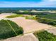 An aerial view of land outlined in yellow, with fields, trees, a house, and a pond at 3187 Wilsons Mills Rd, Smithfield, NC 27577