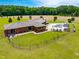 Captivating aerial shot showing the brick home, fenced pool, and beautiful outdoor living space at 3187 Wilsons Mills Rd, Smithfield, NC 27577