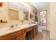 Bathroom featuring a double vanity with sinks, mirror, and decorative wallpaper at 3187 Wilsons Mills Rd, Smithfield, NC 27577