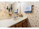 Bathroom featuring a vanity, mirror, and decorative wallpaper at 3187 Wilsons Mills Rd, Smithfield, NC 27577