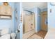 Bathroom featuring a shower, toilet, and vanity with blue walls and wood-look flooring at 3187 Wilsons Mills Rd, Smithfield, NC 27577
