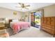 Well-lit bedroom featuring a ceiling fan, carpet, and a sliding glass door to the backyard at 3187 Wilsons Mills Rd, Smithfield, NC 27577
