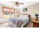 Cozy bedroom featuring a ceiling fan, wood blinds, and a comfortable bed with a chevron patterned throw blanket at 3187 Wilsons Mills Rd, Smithfield, NC 27577