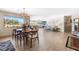 Open-concept dining room featuring hardwood floors and natural light from the large picture window at 3187 Wilsons Mills Rd, Smithfield, NC 27577