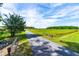 A long driveway leading up to a brick home in a beautiful country setting at 3187 Wilsons Mills Rd, Smithfield, NC 27577