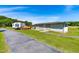 Exterior view of RV, garage, and outdoor amenities like a deck, near a pond, and picnic pavilion at 3187 Wilsons Mills Rd, Smithfield, NC 27577