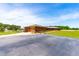 A long, ranch-style brick home with a garage, driveway, and landscaping at 3187 Wilsons Mills Rd, Smithfield, NC 27577