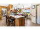 View of the kitchen featuring wood cabinets, a breakfast bar with seating, and a view to the dining area at 3187 Wilsons Mills Rd, Smithfield, NC 27577
