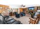 Living room with stone fireplace, wood paneled walls, and an open view to the kitchen at 3187 Wilsons Mills Rd, Smithfield, NC 27577