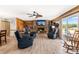 Living room features stone fireplace, wood paneled walls, access to a patio, and comfortable seating at 3187 Wilsons Mills Rd, Smithfield, NC 27577