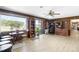 Spacious living room area with a ceiling fan, wood paneling, and sliding glass doors at 3187 Wilsons Mills Rd, Smithfield, NC 27577