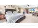 Spacious main bedroom featuring a large bed, ceiling fan, and sliding glass doors to the outside at 3187 Wilsons Mills Rd, Smithfield, NC 27577