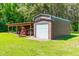 Durable metal outbuilding with roll-up door and attached carport, perfect for storage and equipment at 3187 Wilsons Mills Rd, Smithfield, NC 27577