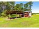 Well-maintained metal outbuilding with attached shelter, ideal for equipment storage on the property at 3187 Wilsons Mills Rd, Smithfield, NC 27577